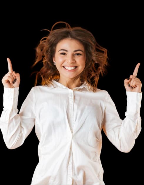 A smiling dental professional pointing upward